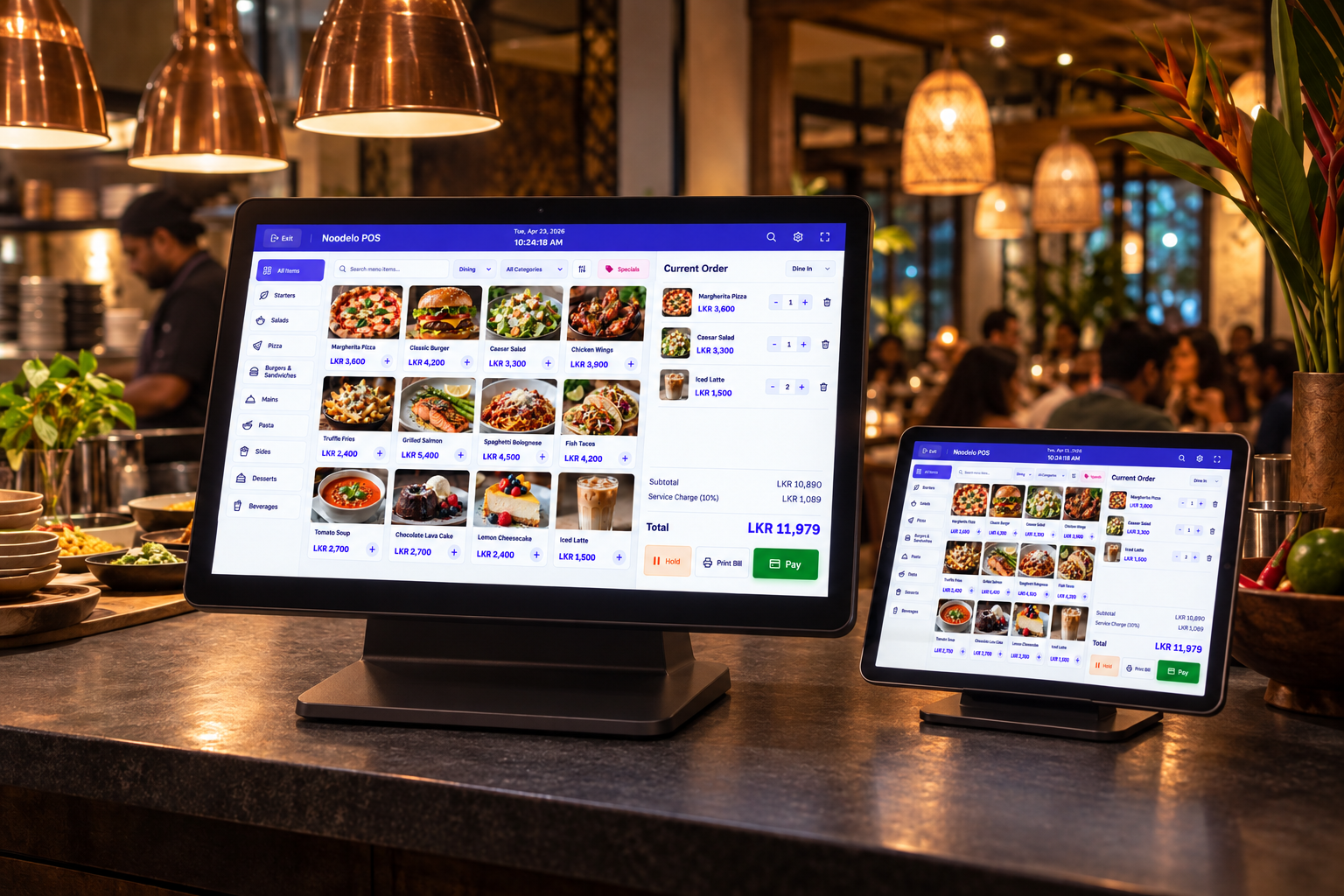 Noodelo POS interface on a restaurant counter terminal and nearby tablet